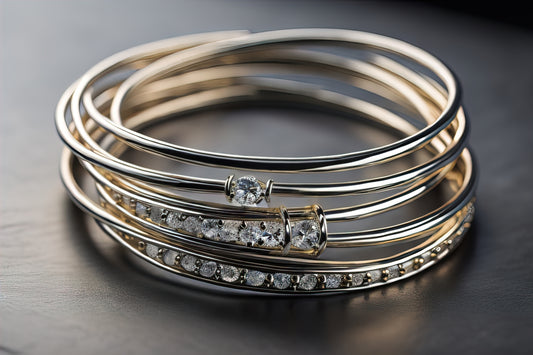 Elegant gold bangles adorned with sparkling gemstones, arranged in a layered stack on a dark, reflective surface, showcasing intricate detailing and luxurious craftsmanship - Mia Ishaaq
