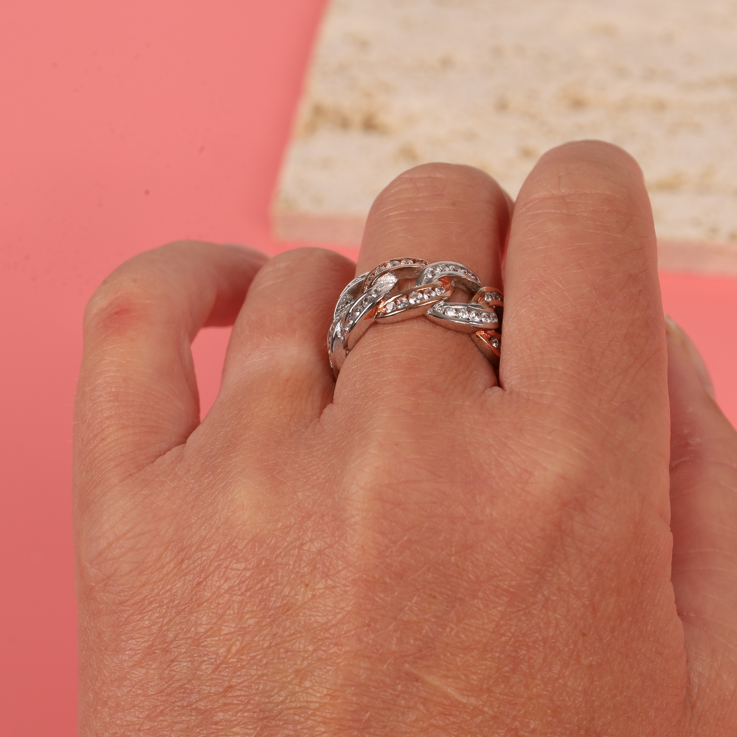 Model's hand showing the width and intricate design of the Cuban link chain ring - Mia Ishaaq