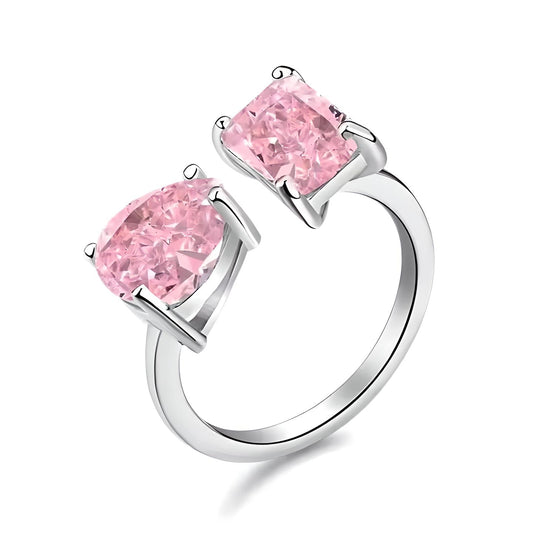 Mia Ishaaq's Pink Radiance Open Ring showcases brilliant pink stones elegantly set against a white background.