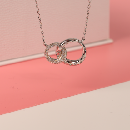 925 sterling silver interlocking circle eternity friendship necklace hanging down beside our gift box on a pink background - Mia Ishaaq