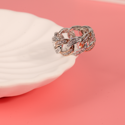 Cuban link ring draped over the edge of a white ceramic bowl on a pink background - Mia Ishaaq