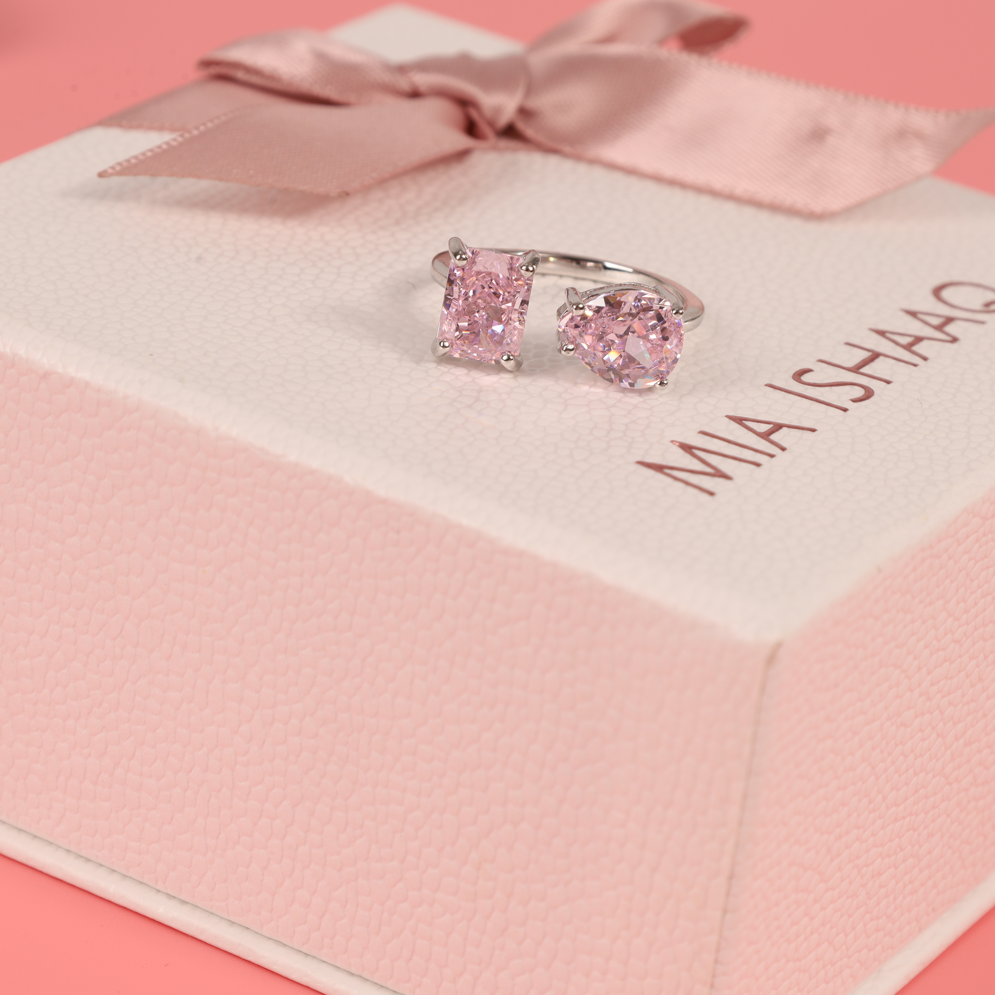 Ring with pink cubic zirconia placed atop our signature gift box - Mia Ishaaq