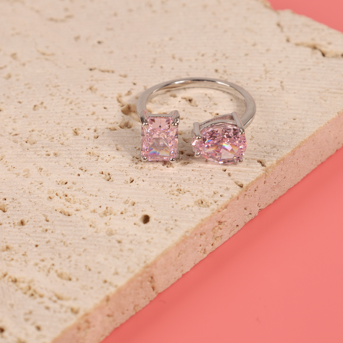 Sterling silver open ring on a natural colour prop with a pink backdrop - Mia Ishaaq