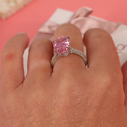 A hand model wearing the Blush Drop Elegance Ring, showcasing the ring's stunning pink cubic zirconia against a soft skin tone - Mia Ishaaq