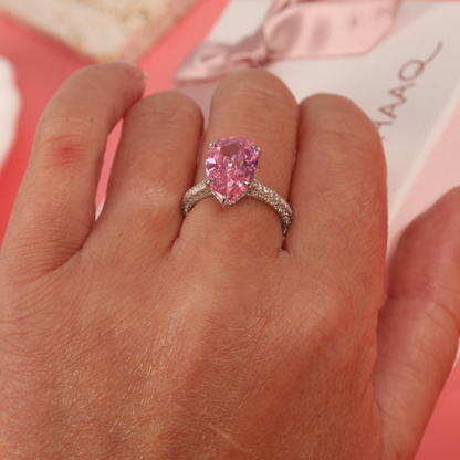 Close-up view of the Blush Drop Elegance Ring on a hand model, highlighting the ring's unique drop shape and sparkling pink centre stone - Mia Ishaaq