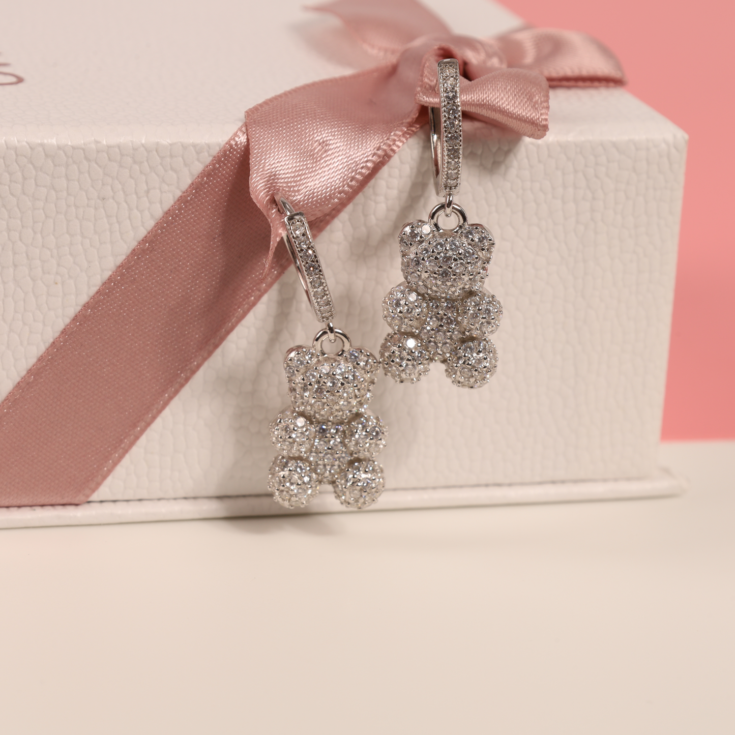 Teddy bear dangle earrings set against a white background alongside our signature box, showcasing their elegant design and perfect gift presentation - Mia Ishaaq