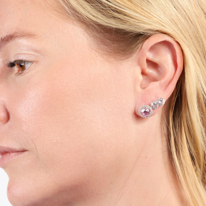 Close-up of a woman's ear adorned with the Mia Ishaaq 925 Sterling Silver PINK CZ Stud Earrings.