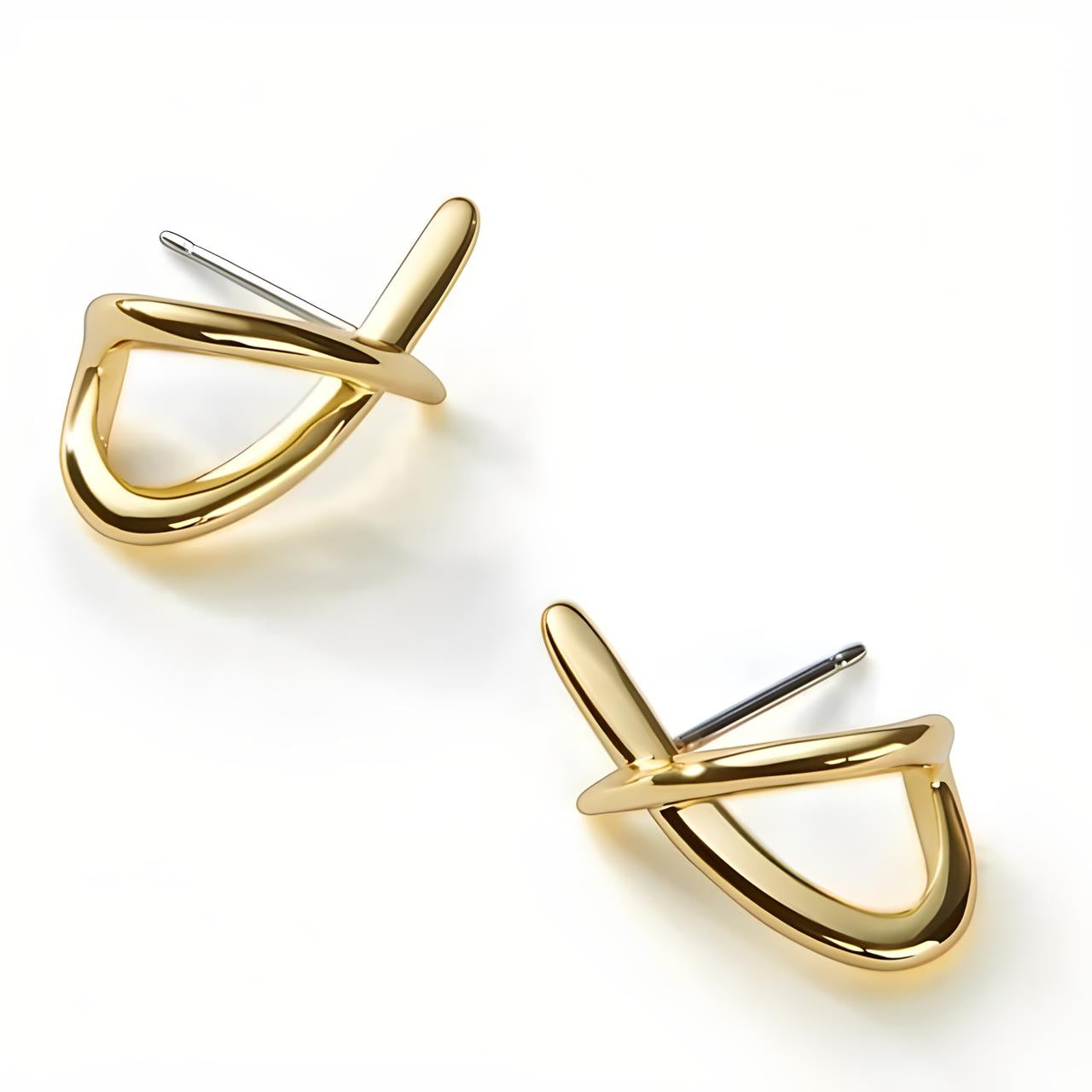 Pair of Gold Loop Cross Stud Earrings placed on their side on the plain white background - Mia Ishaaq